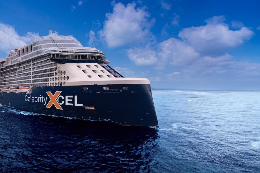 Large cruise ship with the Celebrity Xcel logo on the side sailing on open waters.
